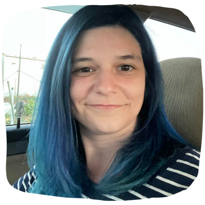 photo of white female-presenting woman with blue hair